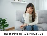 Small photo of Depression and mental illness. Beautiful Asian woman disappointed and sad after receiving bad news. Stressed girl confused with unhappy problems in life, arguing with her boyfriend.