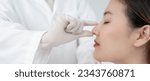 Small photo of plastic surgery, beauty, Surgeon or beautician touching woman face, surgical procedure that involve altering shape of nose, doctor examines patient nose before rhinoplasty, medical assistance, health