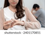 Small photo of Divorce. Woman remove married ring. Couples desperate and disappointed after marriage. Husband wife sad, upset and frustrated after quarrels conflict. distrust, love problems, betrayals, family, lover