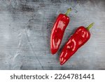 Fresh healthy red paprika above blue moody background.