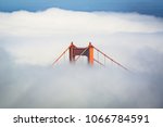 San Francisco Golden Gate Bridge poking through thick fog during the day