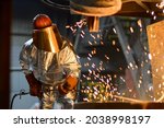 Small photo of A steelworker when casting draining metal from a cupola furnace. Metallurgy.