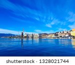 View of harbour instalation, wear houses, ships and city buildings against blue sky with beautiful white clouds, City port of Rijeka, Croatia