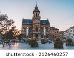 Small photo of Brussels, BELGIUM - October 8, 2021: Twon Hall of Anderlecht at sunset. Families and people enjoying the sunset at town hall square