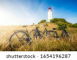 Scenic panoramic view of famous Lighthouse Dornbusch on the beautiful island Hiddensee with classical tourist bicycles on a sunny summer day with blue sky, Baltic Sea, Mecklenburg-Vorpommern, Germany