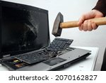 The man destroyed laptop with a hammer. Nervous work, buggy computer, errors, slow Internet, not saved in the game, printed text, hung. Bad old computer failed, does not turn on, keyboard