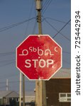 Small photo of Bilingual octagon red stop sign with in Inuktitut (Syllabic), and Englis