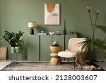 Small photo of Elegant living room interior design with mockup poster frame, modern frotte armchair, wooden commode and stylish accessories. Green eucalyptus wall. Template. Copy space.