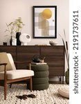Small photo of Interior design of harmonized living room with brown commode, design boucle armchair, coffee table pouf, decoration, mock up poster frame and elegant personal accessories. Modern home decor. Template.