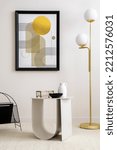 Small photo of Interior design of harmonized living room with mock up poster frame, coffee table, gold lamp, decoration and personal accessories. Beige wall. Home decor. Template.