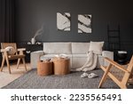 Small photo of Elegant composition of living room interior with mock up poster frame, beige modular sofa, wooden coffee table, slippers, rattan armchair, braided plaid and personal accessories. Home decor. Template.