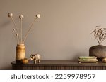 Creative composition of living room interior with wooden sideboard, stylish vase with dried flowers, stylish casket, nuts in bowl, brown wall and personal accessories. Home decor. Template. 