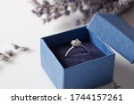Image of wedding rings in a blue gift box. Beautiful rings in a blue box with delicate flowers.