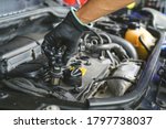 Auto mechanic installing an ignition coil pack.