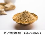 Small photo of Fuller'S Earth Clay OR Multani mitti in a bowl along with raw stones and mortar