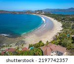 Playa Flamingo, Guanacaste, Costa Rica - Aerial Drone shot of Flamingo Beach - Luxury Homes with Ocean view at white sand Beach and blue Lagoon Bay on the north Pacific Coast line