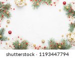 Bright Christmas frame of spruce, red & gold christmas decorations on white background. Copy space. Winter holidays, New Year.