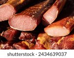 Small photo of Delicious pieces of smoked meat exposed for sale in the market presented for sale on a farmer's market in Kacarevo village, gastro bacon and dry meat products festival called Slaninijada (bacon fest)