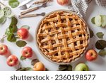 Homemade Apple Pie with fresh apples on white kitchen table, top view, flat lay. Thanksgiving traditional dessert, Thanksgiving tart preparation, autumn bakery. Crispy weather sweets. Recipe