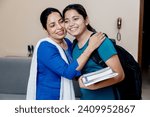 Small photo of Indian mother Wishing her daughter best wishes for exam by kissing her on forehead and hug her