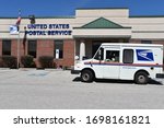 Small photo of King of Prussia, PA/USA-April 7, 2020: United States Post Office truck parks outside the post office building to pick up mail during the COVID-19 virus, since they are considered essential business.