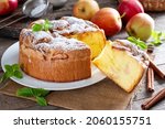 Small photo of Sponge cake or chiffon cake with apples, so soft and delicious with ingredients: eggs, flour, apples on wooden table. Homemade bakery concept for background and wallpaper.