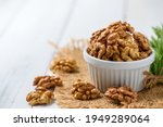 Walnut in white cup on wood background. healthy nuts concept. Walnuts are an excellent source of antioxidants and including LDL cholesterol, which promotes atherosclerosis.