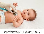 Small photo of Baby auscultation. Pediatrician using a stethoscope listens to the baby's chest, checking the heartbeat. The pediatrician examines the baby. Baby health concept