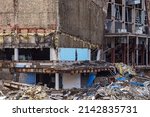 Exterior view of the destroyed building. Collapsed building. Demolished building with debris. Ruin demolishing site after destruction.