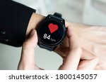 Man using a smartwatch with app checking heart rate.