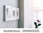 White european electrical socket outlets and switch on gray wall in light modern kitchen by the window. Selective focus