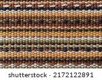 Small photo of Plain weave fabric macro texture. Cloth background with horizontal strips of white, yellow, green, brown and black colors. Textile surface. Colorful woven fabric as design element. Weft and warp.