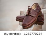 Men's boat shoes on wooden background. Fashion advertising shoes photos.