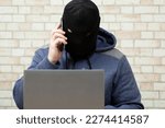 Small photo of Phone fraud.Talking to phone scammers. Withdrawal of money via the Internet.