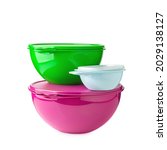 Small photo of Stack of plastic containers. Plastic bowls of green, pink and blue colors on a white background. Food containers. Container with a lid. Pronounced surface structure.