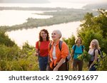 multi generation a group of women friends with backpacks hiking in nature and spending time together. travel tourism concept. Outdoor activities on weekends.