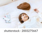 Woman relaxing in a hotel bed