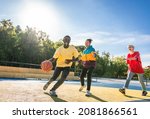 Small photo of Multicultural group of young friends bonding outdoors and having fun - Stylish cool teens gathering at basketball court, friends playing basketball outdoors