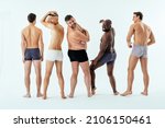 Group of multiethnic men posing for a male edition body positive beauty set. Shirtless guys with different age, and body wearing boxers underwear