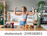 Small photo of Beautiful mature senior woman at home, domestic life and leisure moments - 50-60 years old pretty female adult wearing sportswear eating healthy food after fitness workout