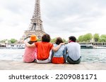 Group of young happy friends visiting Paris and Eiffel Tower, Trocadero area and Seine river - Multicultural group of tourists sightseeing the France capital city