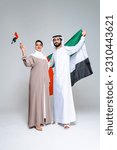 Small photo of Beautiful arab middle-eastern happy couple of lovers wearing traditional abaya and kandora in studio - Arabic muslim adult people bonding and having fun in Dubai, United Arab Emirates