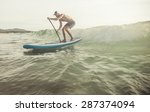 Surfer With Paddle Board...