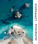 Small photo of Aerial view of Petra tou Romiou, aka Aphrodite's rock a famous tourist travel destination landmark in Paphos, Cyprus. The sea bay of goddess Afroditi birthplace from above.