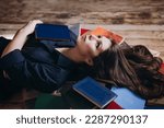 Small photo of A relaxed woman underlie and reads in a room full of books.