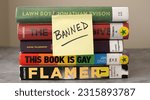 Small photo of Chicago, IL, USA - May 10 2023: A stack of books found on frequently banned book lists with a sticky note saying "banned"