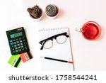 Small photo of credit cards, calculater, notbook pen and glasses on the desk, online shopping, account and saving concept.