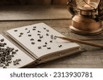 Small photo of English letters are scattered on the notepad page for notes, the concept of grammar, languages, creativity and ideas for a story