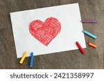 red heart drawn on a white sheet with crayons, valentines day background, love concept