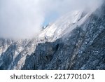 Small photo of Detail of steep and inaccessible rocky mountains in the alps.